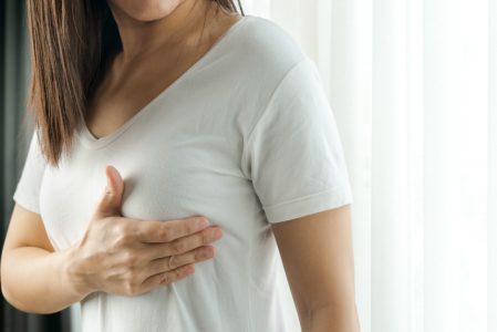 woman-hand-checking-lumps-her-breast-signs-breast-cancer-women-healthcare-concept